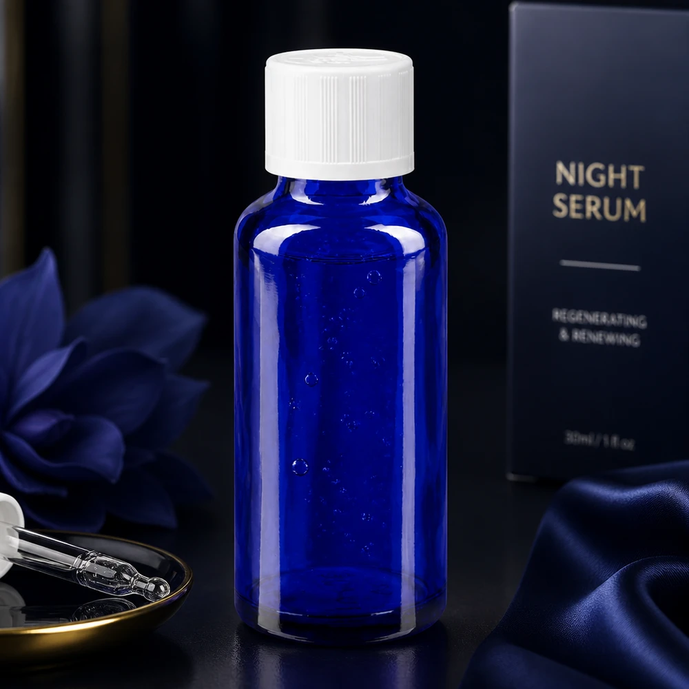 Blaue 30ml Apothekerflasche mit Tropfeinsatz 1,2mm vor luxuriöser Nachtserum-Verpackung in Dunkelblau